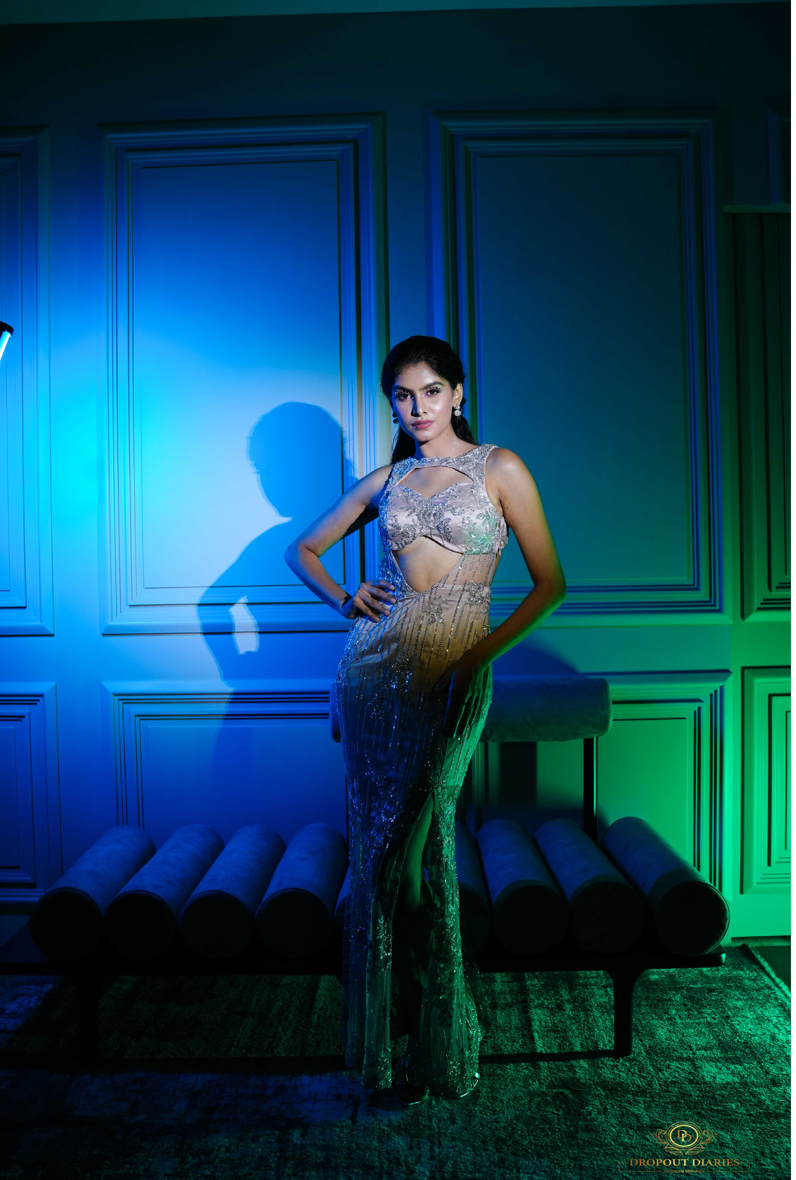 Metallic net gown featuring a front slit and crossover halter neck