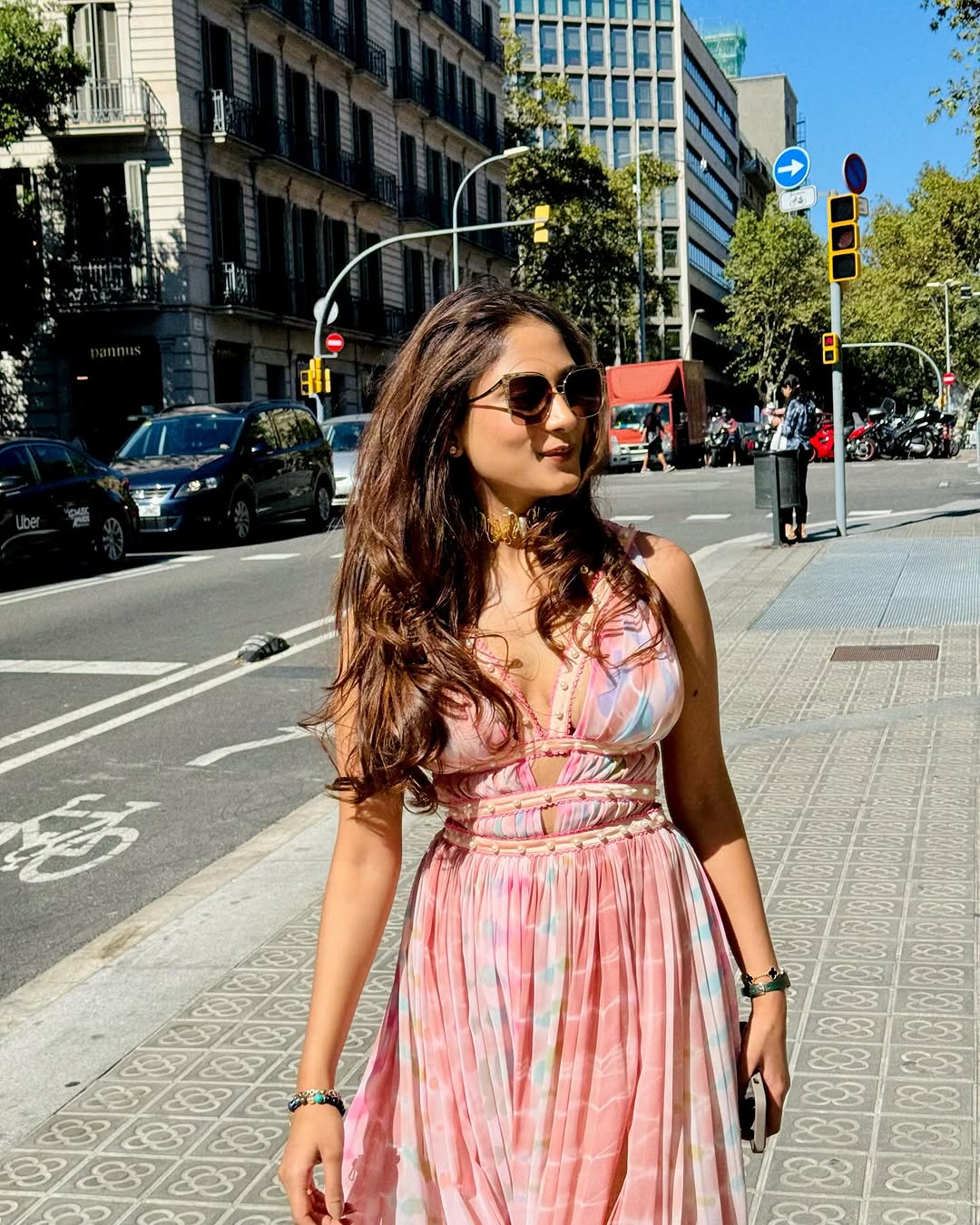 Vacation-ready pink dress with pleated details and deep neckline