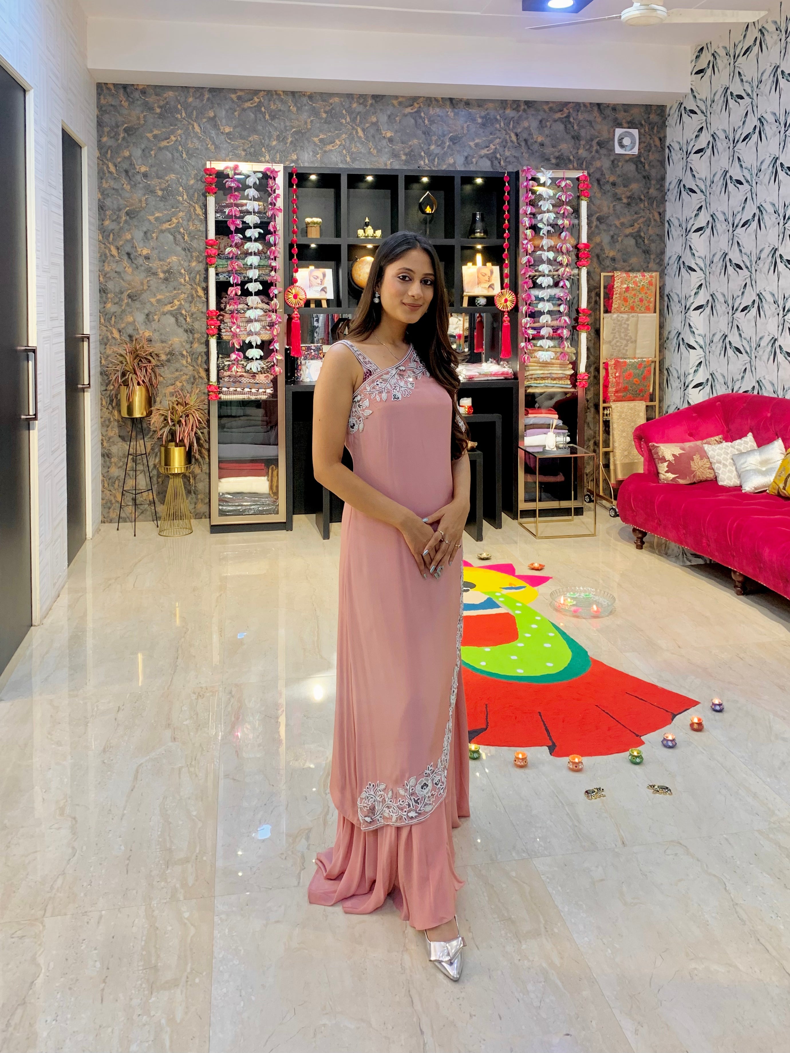 Woman wearing blush pink embellished sharara set with embroidered hem by Prisella
