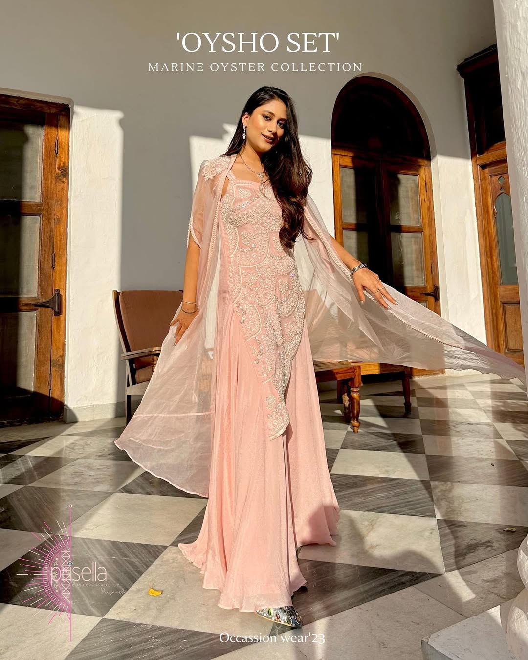 Pink crepe occasion dress featuring intricate beadwork and draped cape