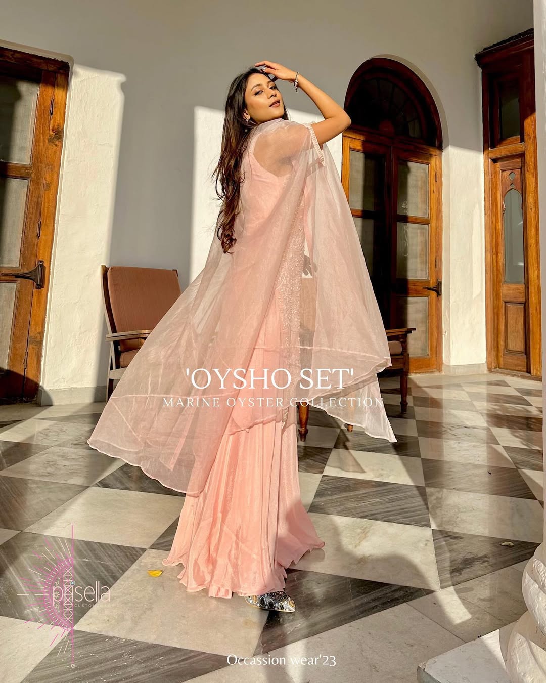 Elegant cape dress with handcrafted embroidery on soft pastel crepe