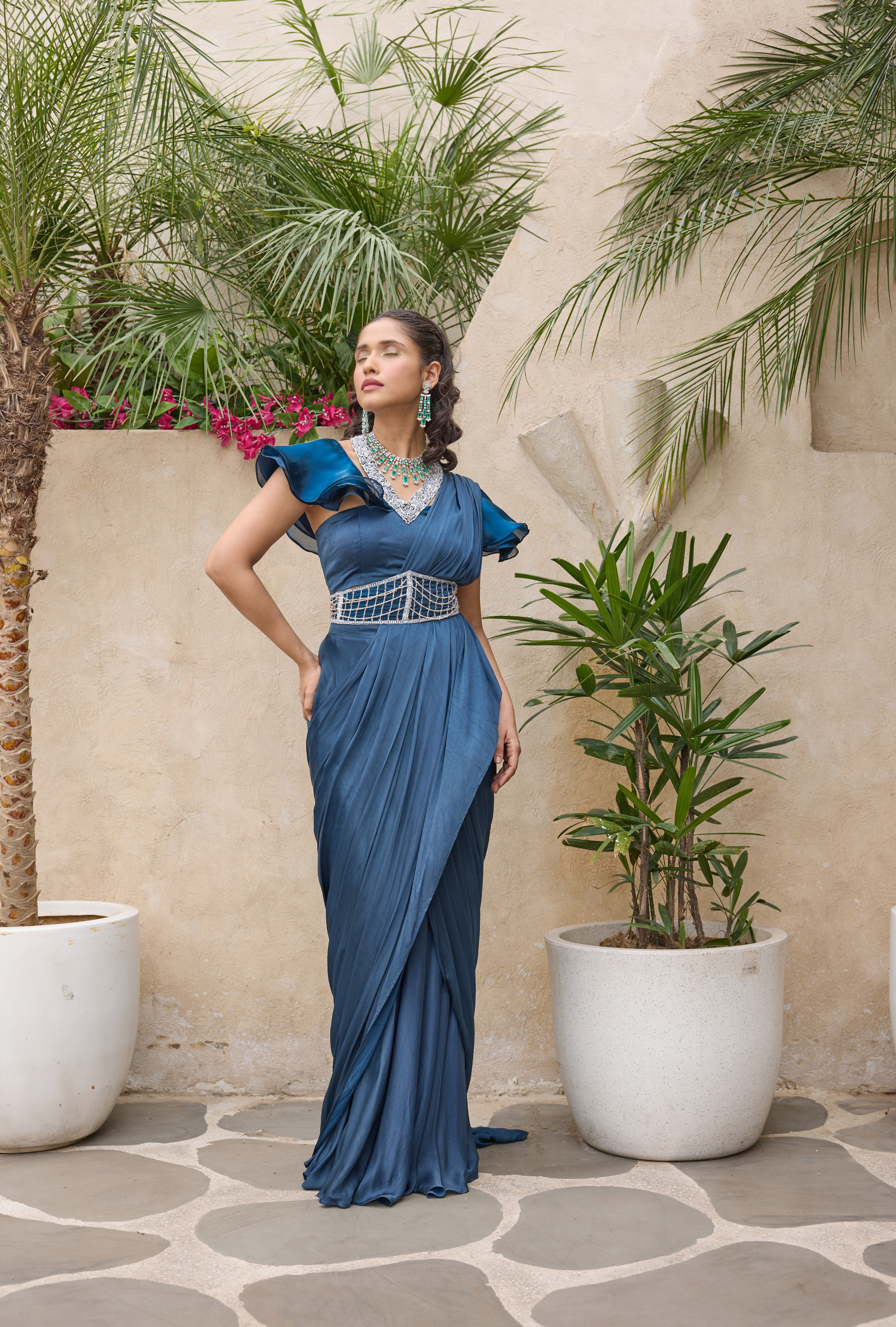 Blue pre-draped satin saree with embroidered belt and cape