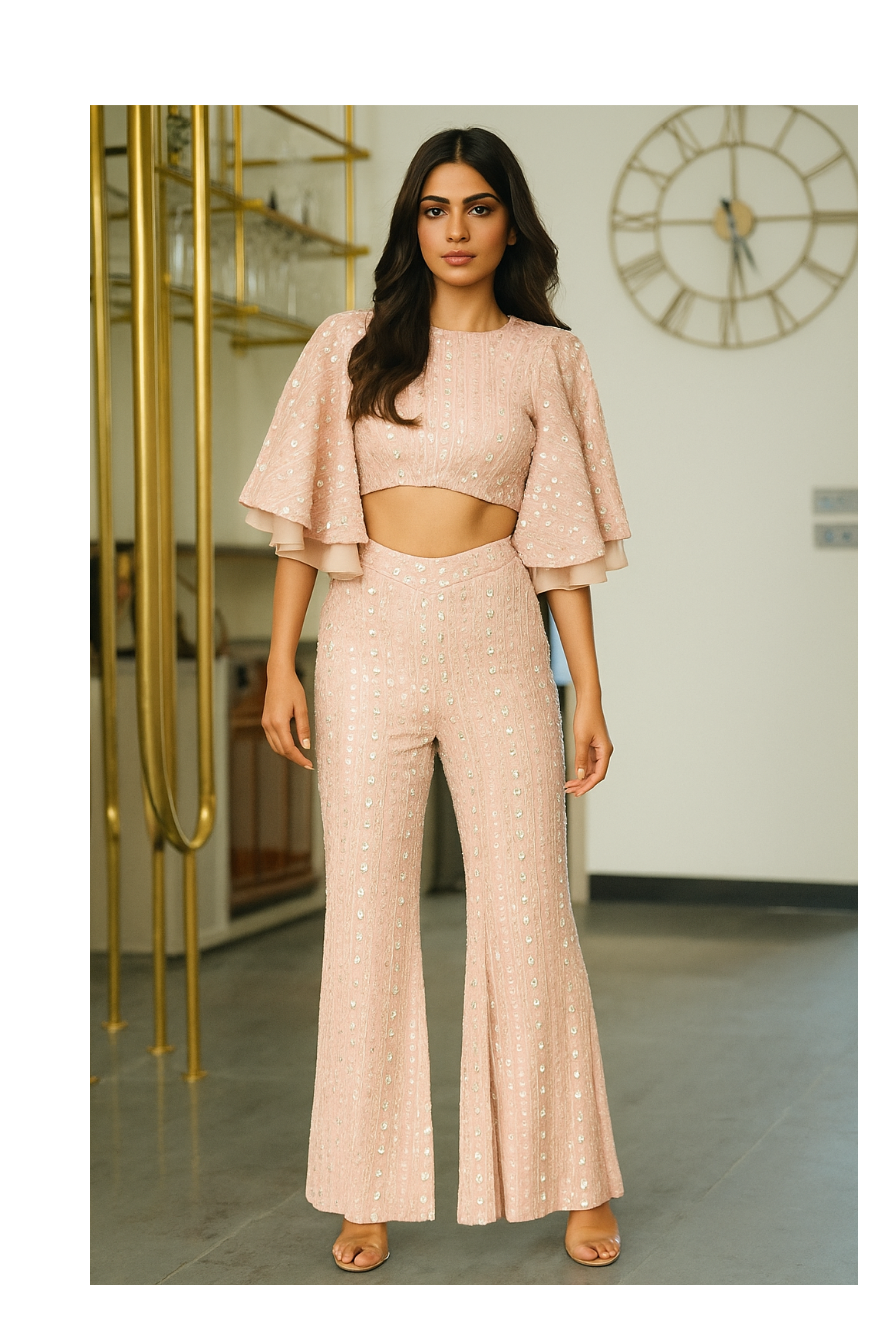 Model wearing a blush pink sequined coord set with a short top and flared pants, designed for cocktail nights, parties, and celebrations.