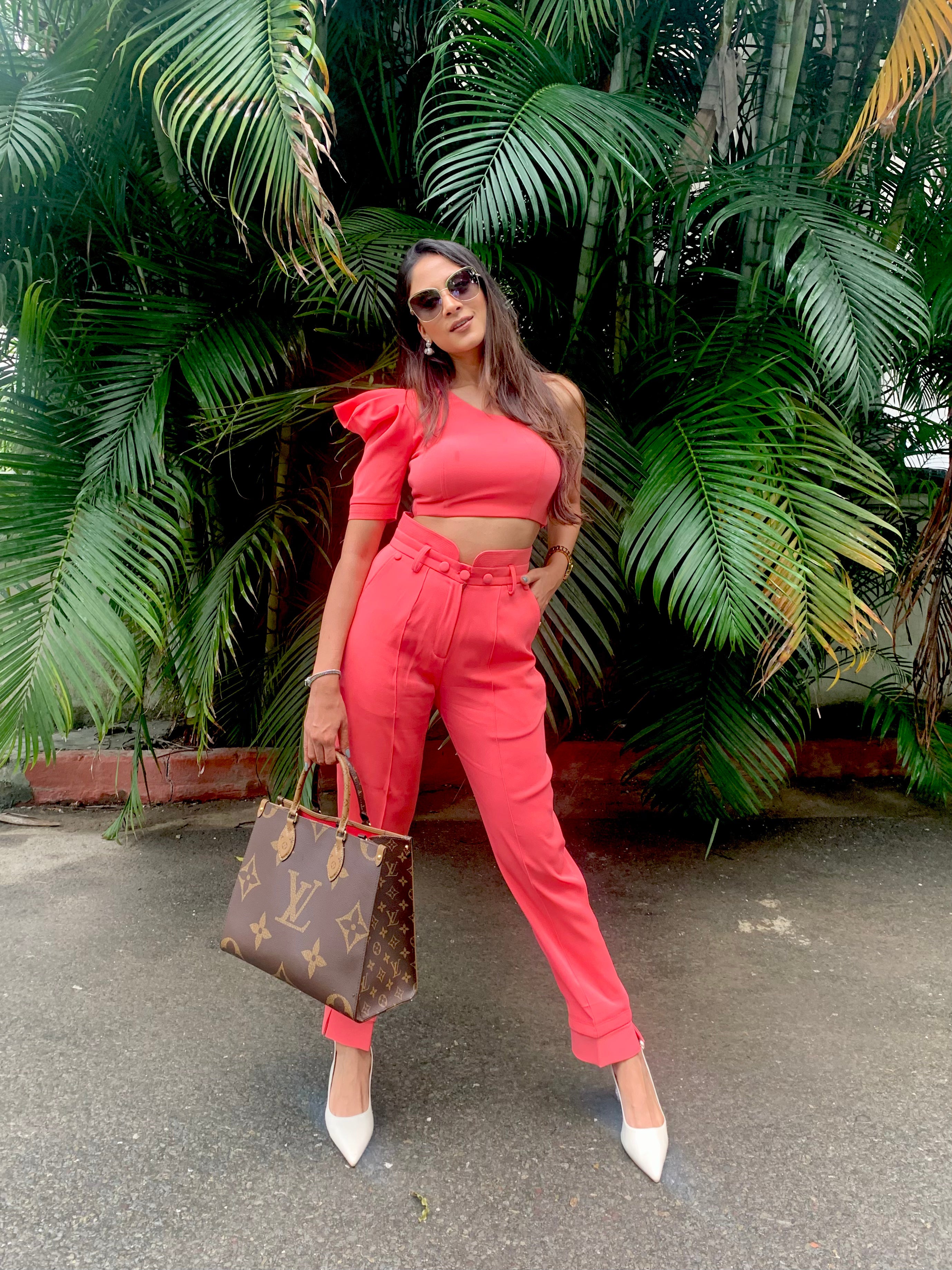Model in coral one-shoulder puff sleeve top and high-waist pants – casual designer coord set by Prisella by priyansha