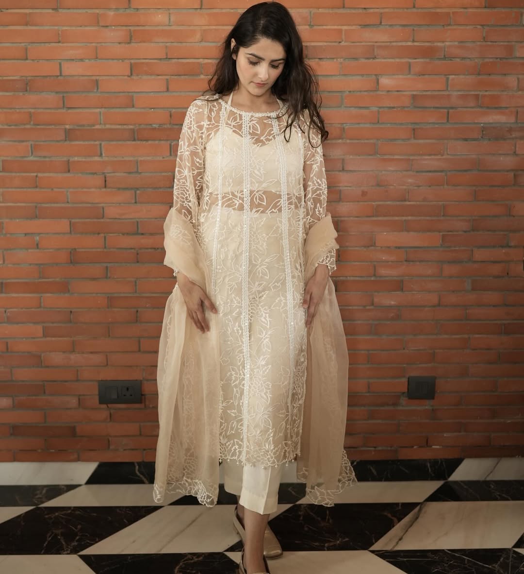 Model in a white embroidered organza top, bandeau, pants, and dupatta – Prisella elegant festivewear

